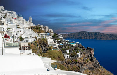 High angle view of townscape by sea against sky
