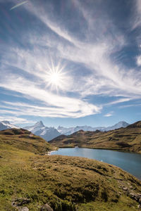 Scenic view of lake against cloudy sky