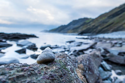 Scenic view of rocks on beach against sky