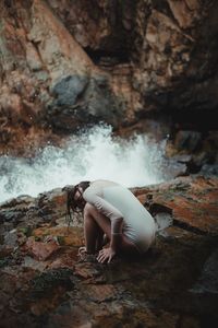 Woman sitting on rock