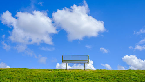 Lifeguard hut on field against sky