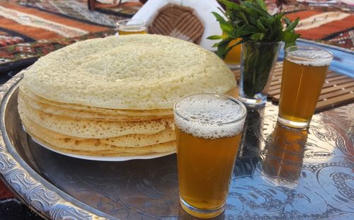 Stacked pancakes and beer on a tray