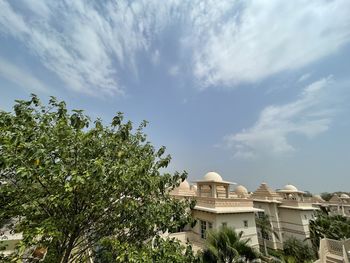 Trees and buildings against sky