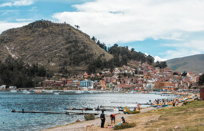 People on beach against sky