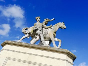 Low angle view of statue against blue sky