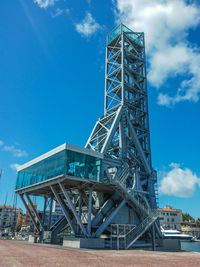 Low angle view of bridge against cloudy sky