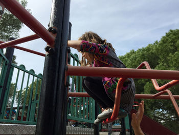 Low angle view of girl playing at playground