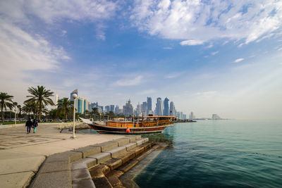 Scenic view of beach and buildings against sky