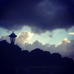 Low angle view of silhouette trees against sky