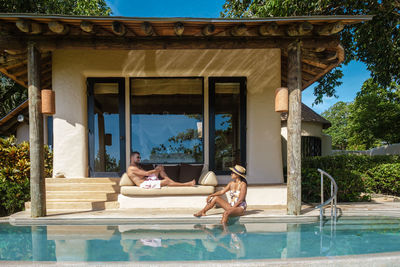 Side view of woman sitting in swimming pool