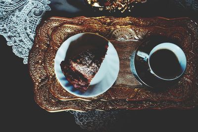 Directly above shot of coffee and bread on tray