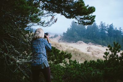 Rear view of man photographing