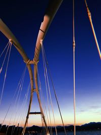 Low angle view of suspension bridge against clear sky