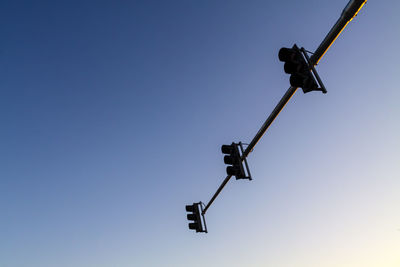 Low angle view of street light against clear blue sky