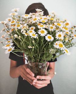 Close-up of hand holding flower bouquet