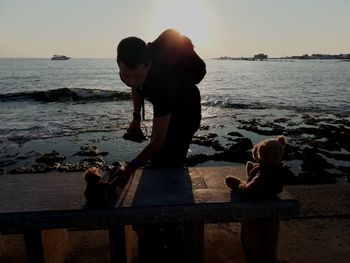 Couple standing on beach against sky