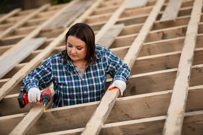 Mid adult woman working at construction site