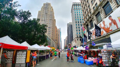 People in city against sky