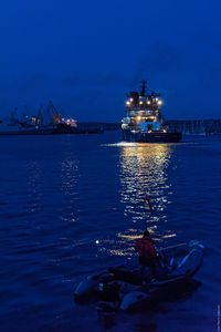 Boats in sea at night