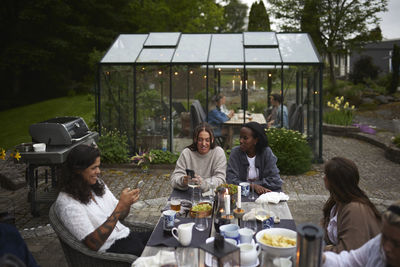 Friends having meal in garden