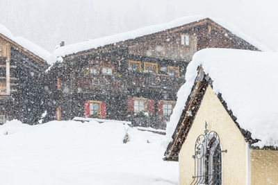 Under a heavy snowfall. walk in the ancient village of sappada. friuli