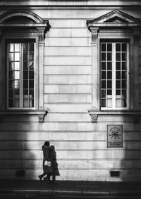 Man walking in front of building