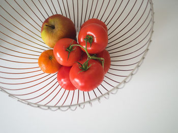 High angle view of strawberries in basket on table