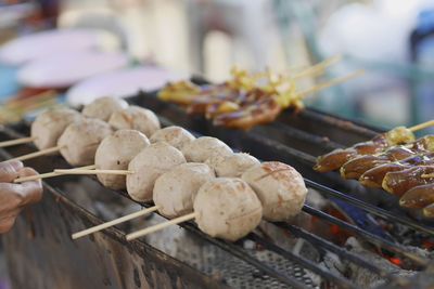 Close-up of hand on barbecue grill