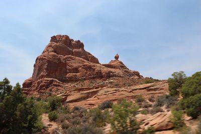 Rock formations on landscape against sky