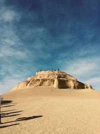 Low angle view of rock formations against sky