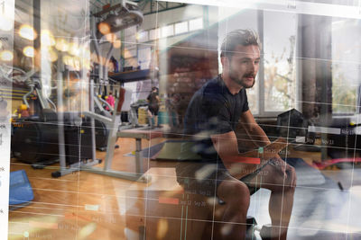 Rear view of man standing in gym