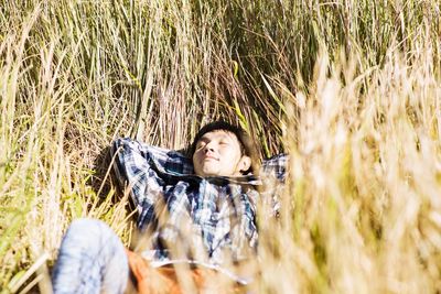 Portrait of man lying in field