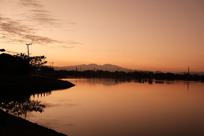 Scenic view of lake against sky during sunrise