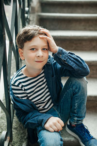 Portrait of boy sitting outdoors