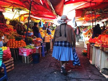 Rear view of people at market stall