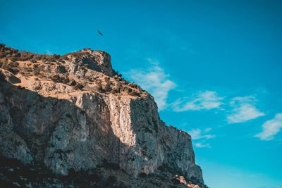 Low angle view of rock formation against sky