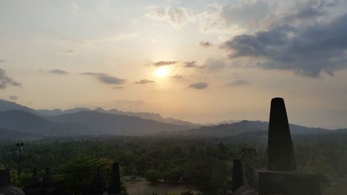 Scenic view of mountains against cloudy sky
