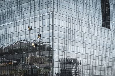 Low angle view of modern glass building in city