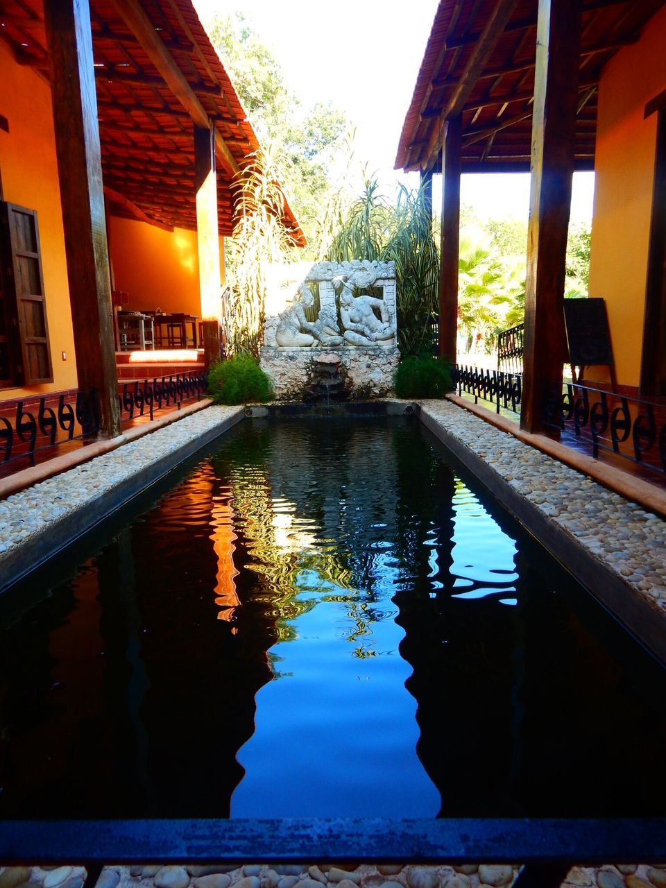 reflection, water, architecture, built structure, swimming pool, building exterior, tourist resort, no people, vacations, day, tree, outdoors, sky, nature, gazebo