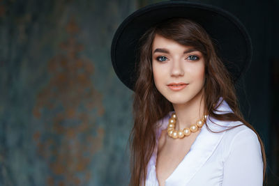 Portrait of a beautiful young woman in retro style in an elegant black hat