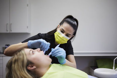 Female dentist with patient in office