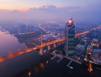 High angle view of city lit up at night