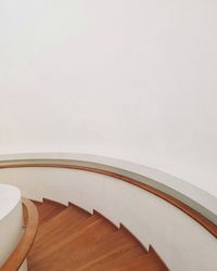 High angle view of railing against white wall