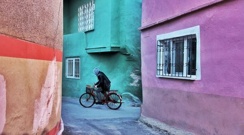 Bicycle on the street between colored walls