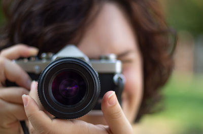 Close-up portrait of woman photographing camera