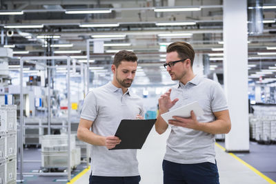 Two men talking in factory shop floor