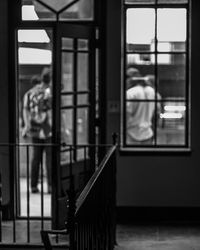 Man looking through window