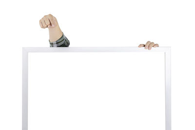 Low angle view of person standing against white background