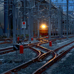 Railroad tracks in city at night