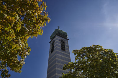 Low angle view of trees and buildings against sky